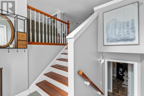 An open-concept dining area and kitchen with blue cabinets, a large island, and pendant lighting. - 65 Beamish Road, East Uniacke