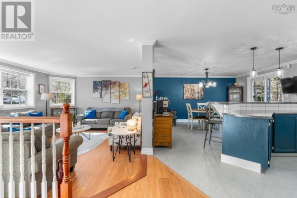 A spacious kitchen with blue shaker cabinets, stainless steel appliances, subway tile backsplash, and granite countertops. - 65 Beamish Road, East Uniacke