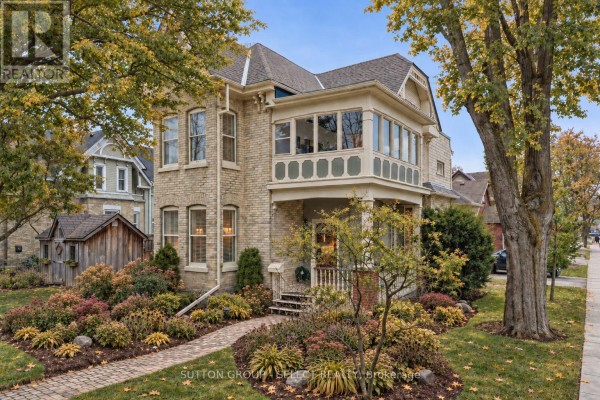 Side view of the house featuring landscaped yard and decorative windows. - 65 Bruce Street, London South