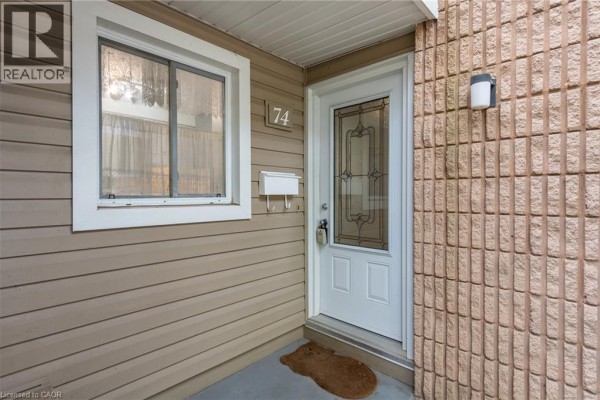 Close-up of townhouse front door with glass inserts and sidelight window. - 65 Glamis Road Unit# 74, Cambridge