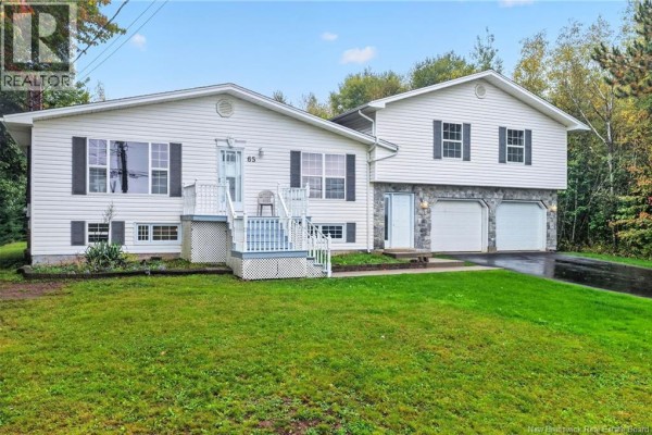 Front entrance of a white split-level house with a white railing and steps. - 65 Northwood Road, Moncton