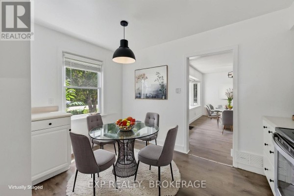 Kitchen dining area with glass table, four chairs, and a doorway leading to another room. - 650 Hillside Drive, Gananoque