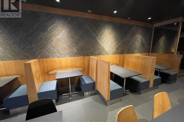 Cozy booth seating with blue cushions and textured wall design - 650 Yonge Street, Toronto