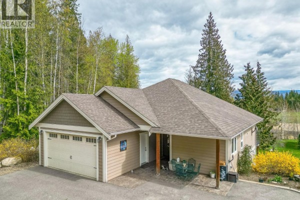 Front of the house with a double garage door, covered entrance, and patio. - 6500, 6450, 6425 1 Avenue Nw Lot# 1,2,3, Salmon Arm