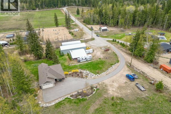Aerial view of the property showing the house, driveway, and surrounding landscape. - 6500, 6450, 6425 1 Avenue Nw Lot# 1,2,3, Salmon Arm