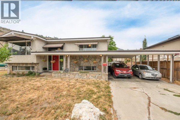 Side view of the house at 651 Richter Street, with Knox Mountain visible behind it. - 651 Richter Street, Kelowna