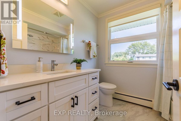 Modern bathroom with white vanity, quartz countertop, and marble shower - 6530 Bunker Road Ottawa