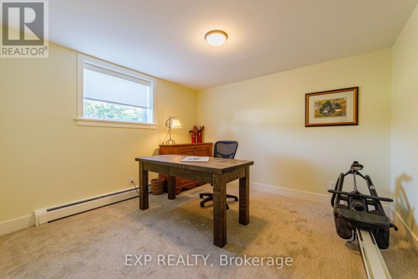 Wooden desk, chair, rowing machine, and artwork - 6530 Bunker Road Ottawa