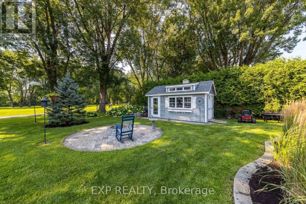 Backyard with shed, patio, fire pit, and rocking chair - 6530 Bunker Road Ottawa