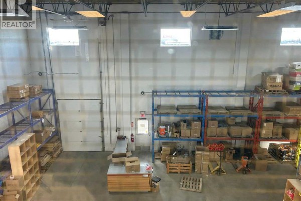Interior warehouse view with organized shelving and packing area - 655 14 Street Sw, Medicine Hat