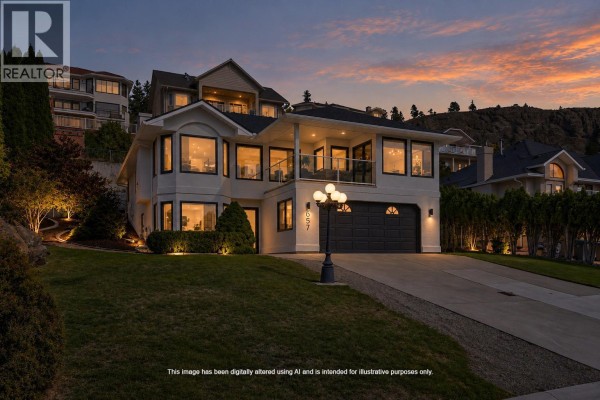 House exterior at dusk with interior lights on, showing windows and balcony. - 657 Royal View Drive, Kelowna