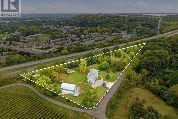 Aerial view showcasing the property boundaries, house, barn, and surrounding landscape. - 6585 Steele Street, Niagara On The Lake