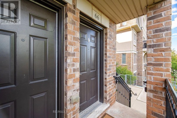 Close-up of two dark brown townhouse doors, one labeled 66. - 66 - 2441 Greenwich Drive, Oakville