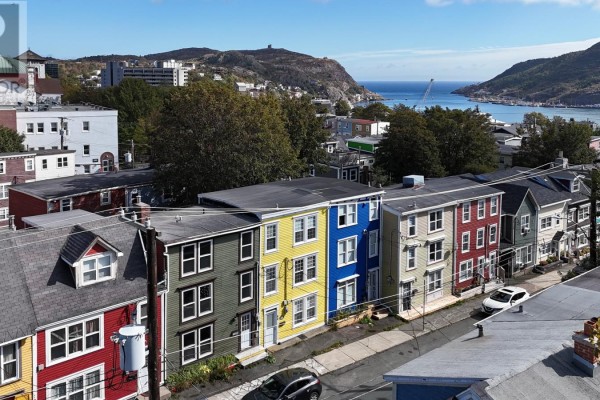 Aerial view of colorful row houses on Colonial Street with a distant view of the St. John's harbour and hills. - 66 Colonial Street, St  John S
