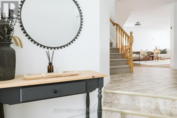 Entryway with a small wooden table, vase, and floral rug, bright white walls. - 66 Highlands Crescent, Collingwood