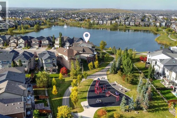 Aerial view of a residential neighborhood with a lake and playground. - 66 Legacy Green Se, Calgary