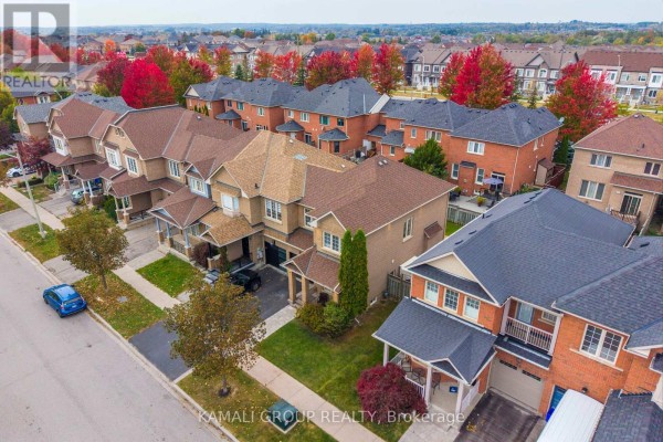 Aerial view of a suburban street with multiple brick townhouses and colorful autumn trees. - 66 Longwood Avenue, Richmond Hill
