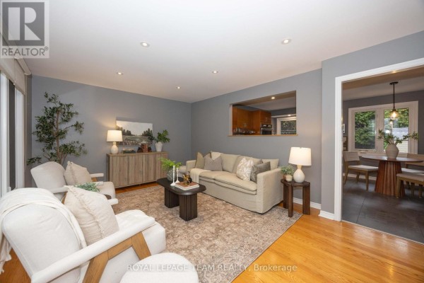 View from living room showing seating area, pass-through to dining room and kitchen. - 66 Still Water Drive, Ottawa
