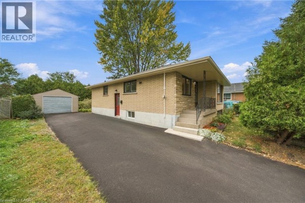 View of the house, driveway, and detached garage on a sunny day. - 662 Dynes Road, Burlington