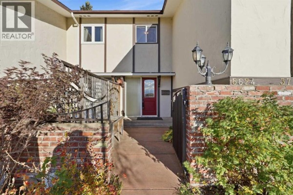 Interior view showing a staircase with wooden treads and a hallway with mirrored closet doors. - 6624 37 Street Sw, Calgary