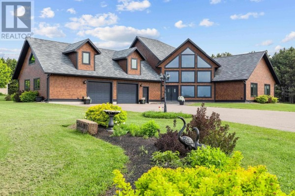 Side view of the house showcasing the large windows and driveway. - 6624 Route 13, Mayfield