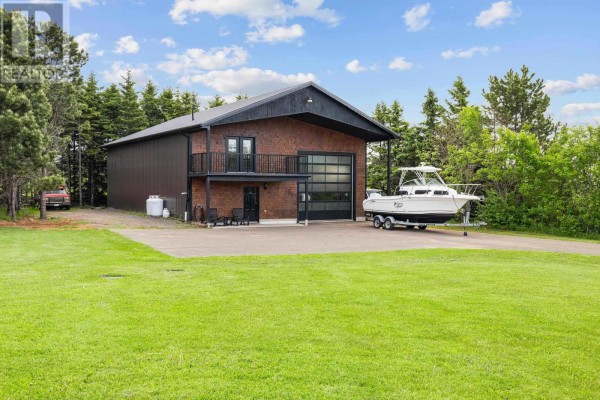 Front view of the property with landscaped yard and trees in the background. - 6624 Route 13, Mayfield