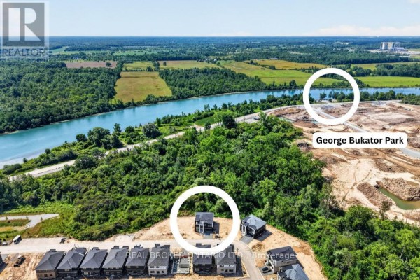 Aerial view showing new housing development near a river and parkland. - 6632 Alexa Common, Niagara Falls