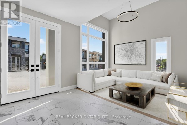 Living room with sectional sofa, large windows, and marble tile flooring. - 6632 Alexa Common, Niagara Falls