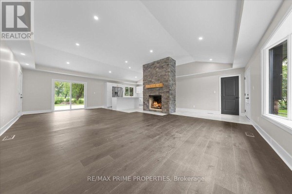 Foyer with white walls, marble tile floor, and a black interior door with a mirror. - 6636 Marina Drive, Ottawa