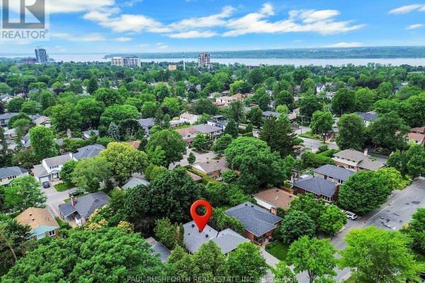 Aerial view of the neighbourhood showing the house and distant water body. - 668 Fraser Avenue, Ottawa