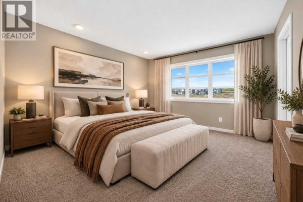 Primary bedroom with king-size bed, bench, nightstands, dresser, and large window with landscape view. - 668 Savanna Drive Ne, Calgary