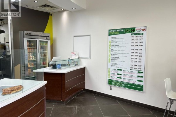 Office counter with computers, phones, a cash register, and storage shelves. - 668 W Erb Street Unit# B9, Waterloo