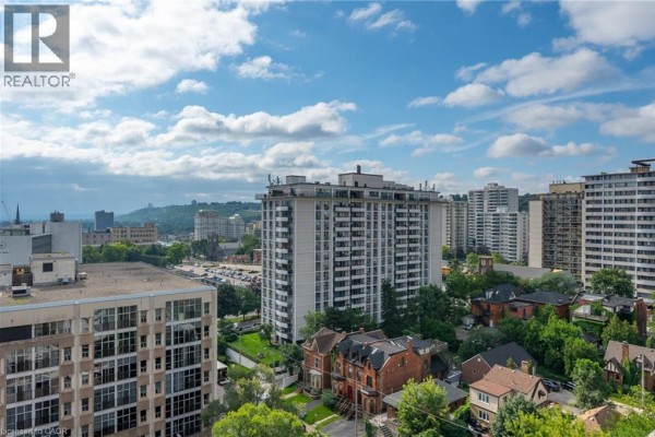Apartment buildings and houses skyline with trees and clouds - 67 Caroline Street S Unit# 13a Hamilton