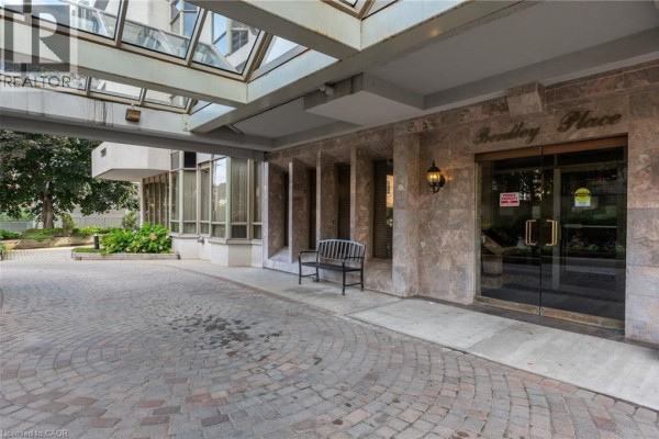 Building entrance with marble facade, covered glass entryway, and double glass doors - 67 Caroline Street S Unit# 13a Hamilton