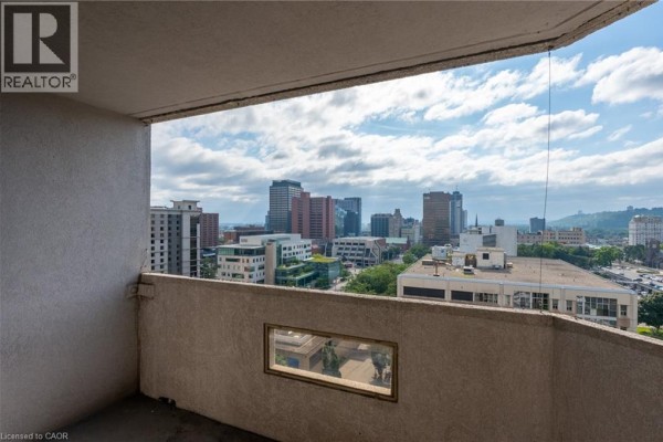 Balcony view with city skyline and Realtor logo - 67 Caroline Street S Unit# 13a Hamilton
