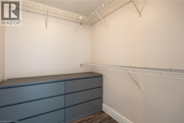 Walk-in closet with gray dresser and wire shelving - 67 Caroline Street S Unit# 13a Hamilton