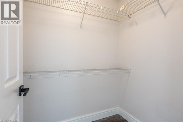 Closet with wire shelving and wood-look flooring - 67 Caroline Street S Unit# 13a Hamilton