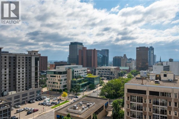 Cityscape view with modern buildings and parking lot - 67 Caroline Street S Unit# 13a Hamilton