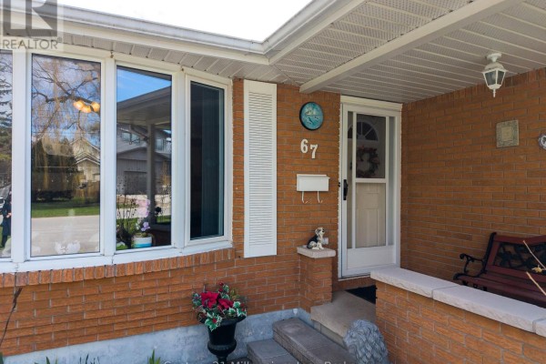Close-up of the front entrance of a brick house with a white door and windows. - 67 East Street E, Collingwood