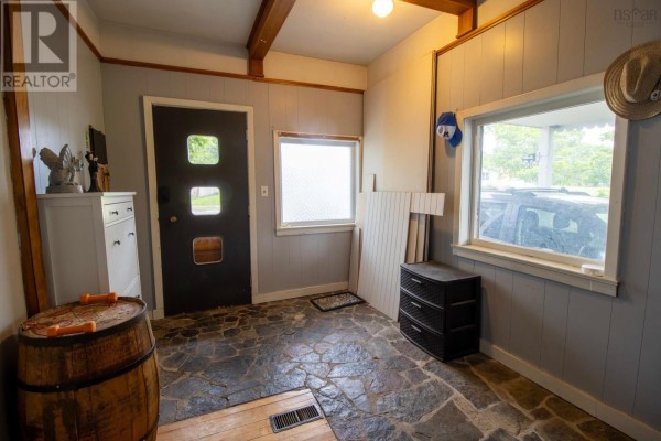 Kitchen with yellow walls, black cabinets, white countertops, double sink, and white stove. - 67 Lawrencetown Lane, Lawrencetown