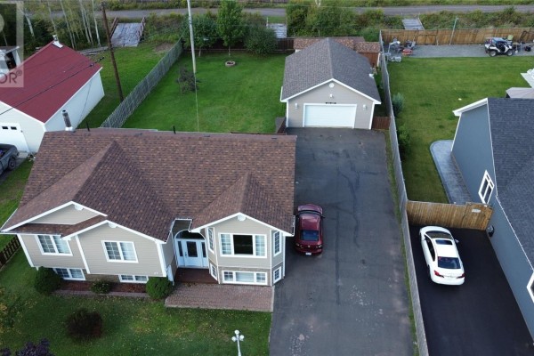 Close-up aerial view of the front entrance and bay windows of the beige house. - 67 Marshalls Drive, Bishop S Falls