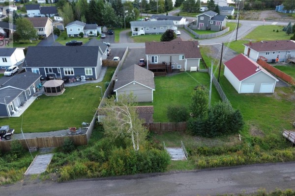 Aerial view of the rear of the property, showing the house, yard, and surrounding neighborhood. - 67 Marshalls Drive, Bishop S Falls