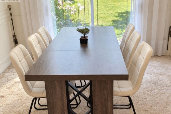 Dining table with eight chairs and a decorative plant, set on a plush carpet. - 675 Waverly Street N, Oshawa