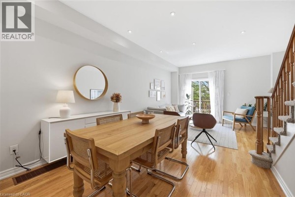 Interior view of a white hallway with a door at the end and open shelving. - 678 Rowley Common, Burlington