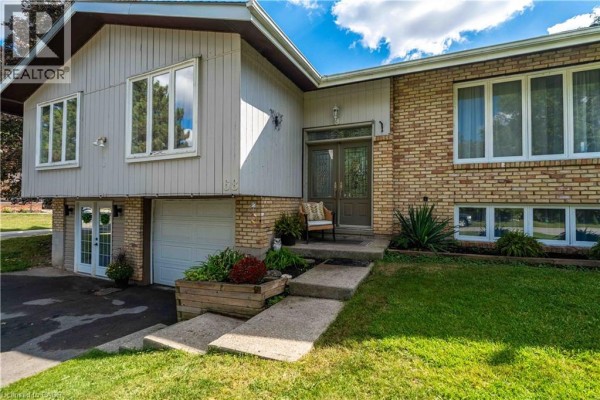 Front entrance with brick accents and a concrete pathway leading to the door. - 68 Aberdeen Street, Caledonia