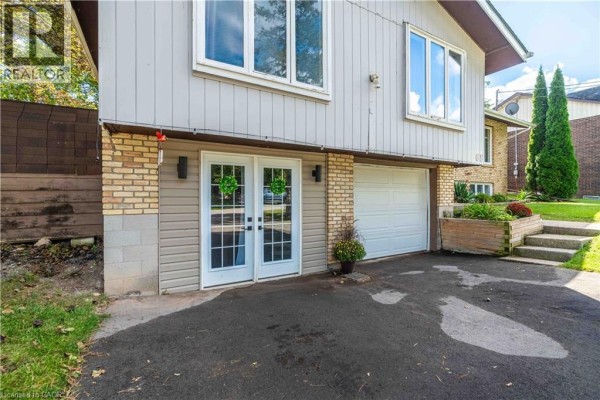Close-up of the house's lower level with double doors and a garage door. - 68 Aberdeen Street, Caledonia