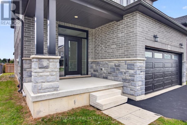 Close-up of the front porch and entrance with stone and brick details. - 68 Davidson Drive W, Stratford