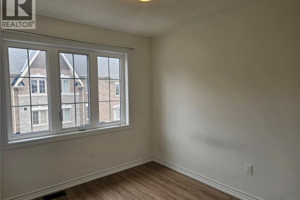 Empty room with wood floors and a glass door leading outside. - 68 First Street Unit# 34, Orangeville
