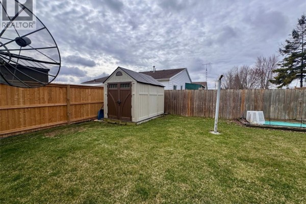 Fenced backyard with shed, satellite dish, and pool - 68 Greenbriar Trail Wallaceburg