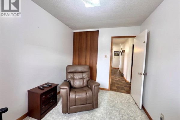 Leather recliner and dresser in room with hallway view - 68 Greenbriar Trail Wallaceburg